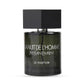 Black Yves Saint Laurent bottle with dark label and cap, featuring white text, isolated on white background.