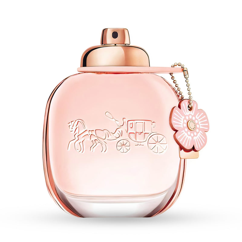 Pink perfume bottle with a floral charm and gold cap.