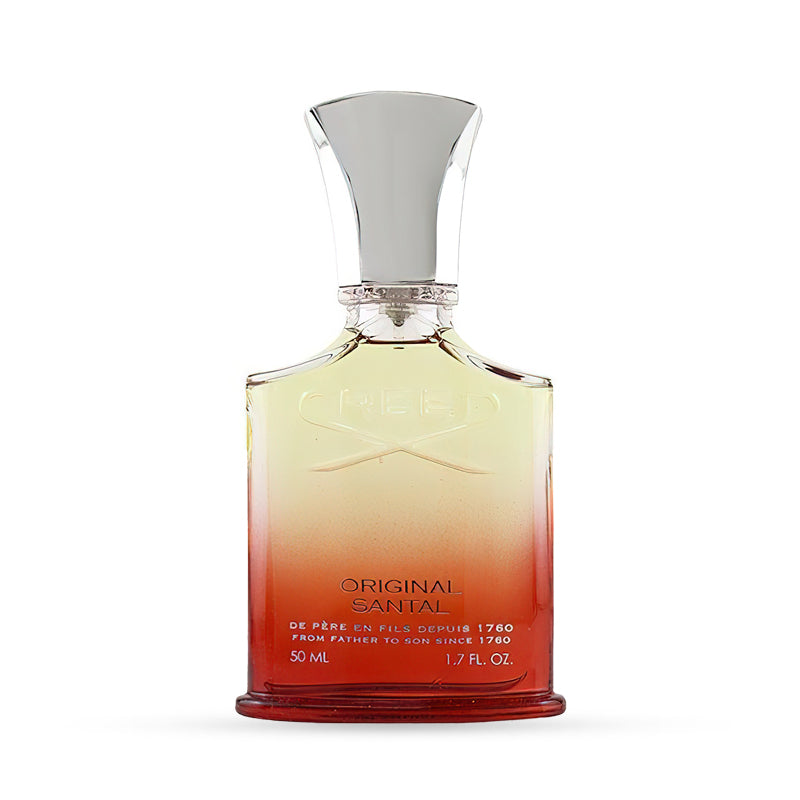 Elegant perfume bottle with ombre red and gold design, featuring a white ornate cap.