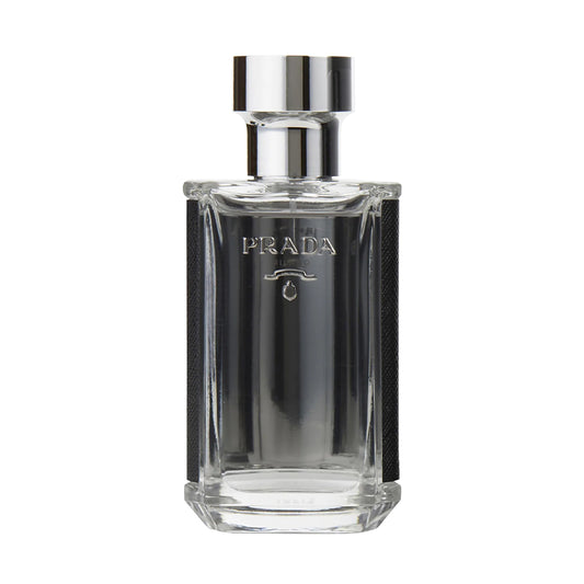 Clear glass bottle of Prada men's fragrance with a silver cap, showcasing elegant branding and minimalist design.