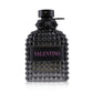 Luxurious Valentino perfume bottle with black studded design and pink lettering.